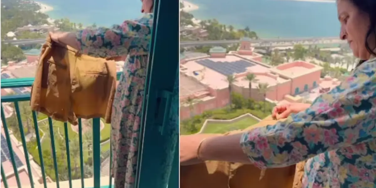 Woman dries clothes on balcony 5 star resort in Dubai